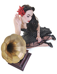 Image showing pretty girl listening music on old gramophone