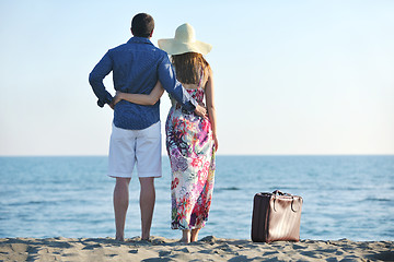 Image showing couple on beach with travel bag