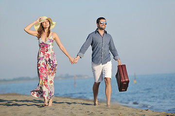 Image showing couple on beach with travel bag