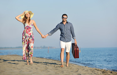 Image showing couple on beach with travel bag