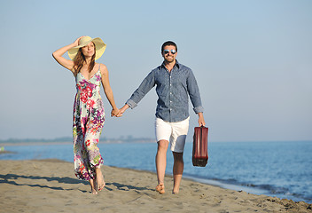 Image showing couple on beach with travel bag