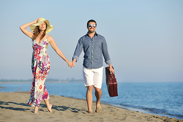 Image showing couple on beach with travel bag