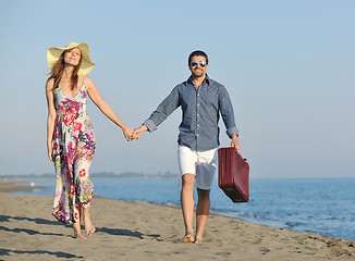 Image showing couple on beach with travel bag