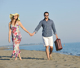 Image showing couple on beach with travel bag