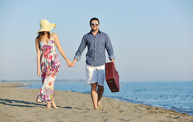 Image showing couple on beach with travel bag