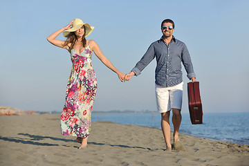 Image showing couple on beach with travel bag