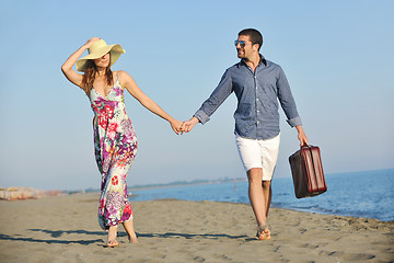 Image showing couple on beach with travel bag