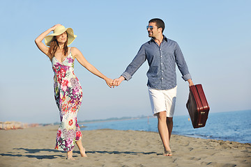 Image showing couple on beach with travel bag