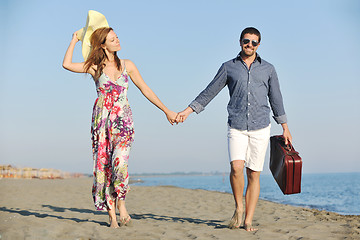 Image showing couple on beach with travel bag