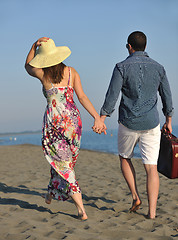 Image showing couple on beach with travel bag