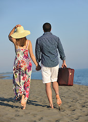 Image showing couple on beach with travel bag