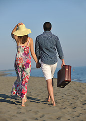 Image showing couple on beach with travel bag