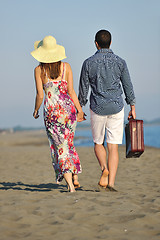 Image showing couple on beach with travel bag