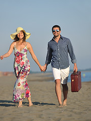 Image showing couple on beach with travel bag