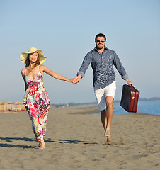 Image showing couple on beach with travel bag