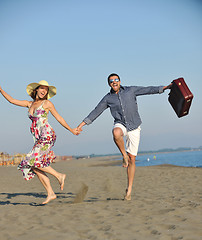 Image showing couple on beach with travel bag