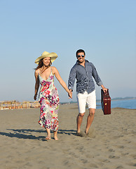 Image showing couple on beach with travel bag