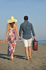 Image showing couple on beach with travel bag