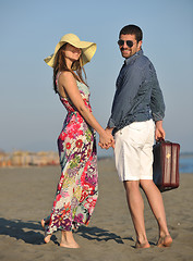 Image showing couple on beach with travel bag