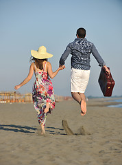 Image showing couple on beach with travel bag