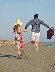 Image showing couple on beach with travel bag