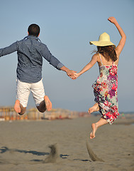 Image showing couple on beach with travel bag