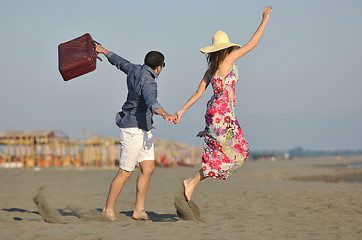 Image showing couple on beach with travel bag