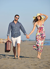 Image showing couple on beach with travel bag