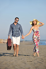 Image showing couple on beach with travel bag