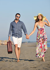 Image showing couple on beach with travel bag