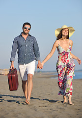 Image showing couple on beach with travel bag