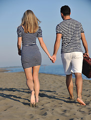 Image showing couple on beach with travel bag