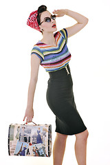 Image showing pretty young happy woman with travel bag waiting and posing isol