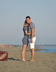 Image showing couple on beach with travel bag