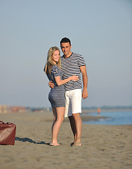 Image showing couple on beach with travel bag