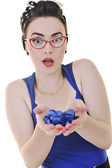 Image showing young woman holding blue flower in hands