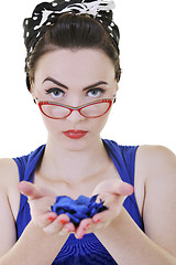 Image showing young woman holding blue flower in hands