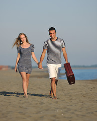 Image showing couple on beach with travel bag