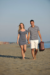 Image showing couple on beach with travel bag