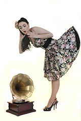 Image showing pretty girl listening music on old gramophone