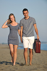 Image showing couple on beach with travel bag