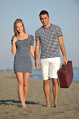 Image showing couple on beach with travel bag