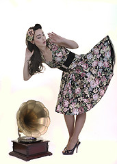 Image showing pretty girl listening music on old gramophone