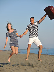 Image showing couple on beach with travel bag