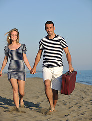 Image showing couple on beach with travel bag