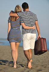 Image showing couple on beach with travel bag