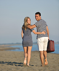 Image showing couple on beach with travel bag