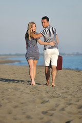 Image showing couple on beach with travel bag