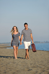 Image showing couple on beach with travel bag