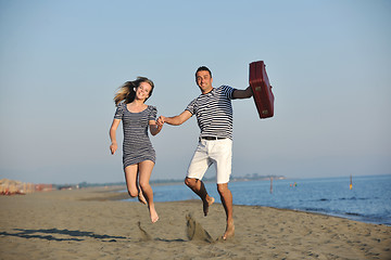 Image showing couple on beach with travel bag